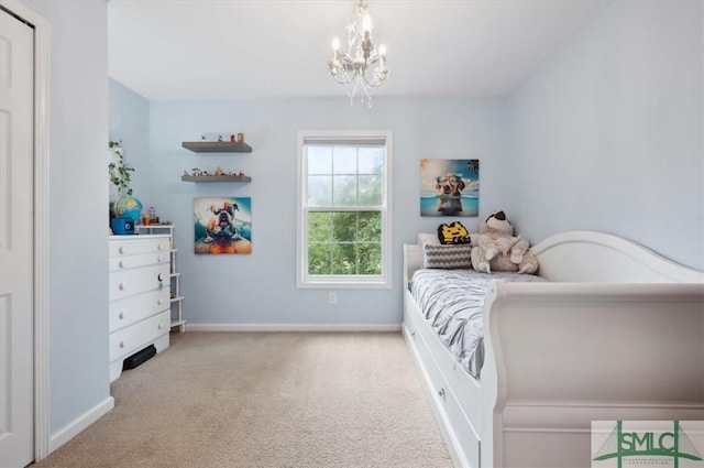 bedroom featuring light carpet and a notable chandelier