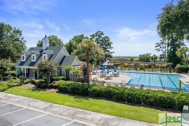 view of swimming pool with a patio area and a pergola