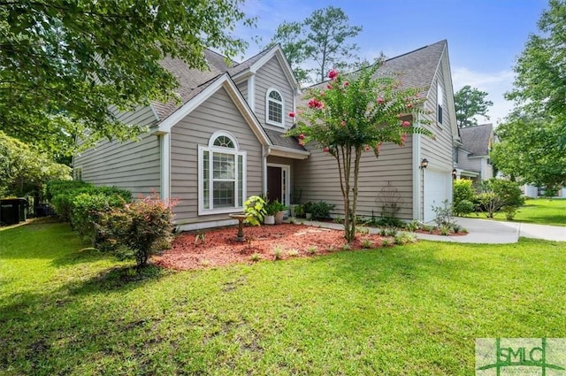 view of front of property featuring a garage and a front lawn