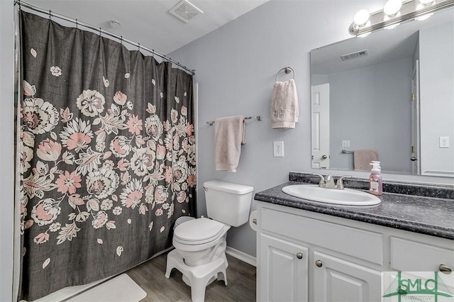 bathroom featuring hardwood / wood-style floors, vanity, and toilet