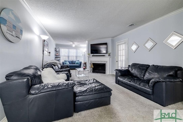 carpeted living room with a wealth of natural light, a textured ceiling, and ornamental molding