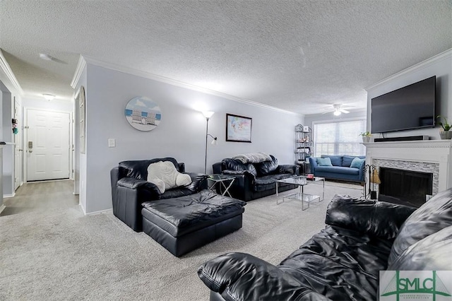 carpeted living room featuring crown molding, ceiling fan, a stone fireplace, and a textured ceiling