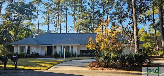 ranch-style home featuring a front yard