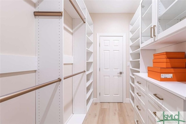 walk in closet featuring light hardwood / wood-style floors