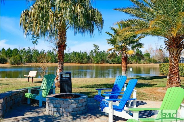 view of patio / terrace with a fire pit and a water view