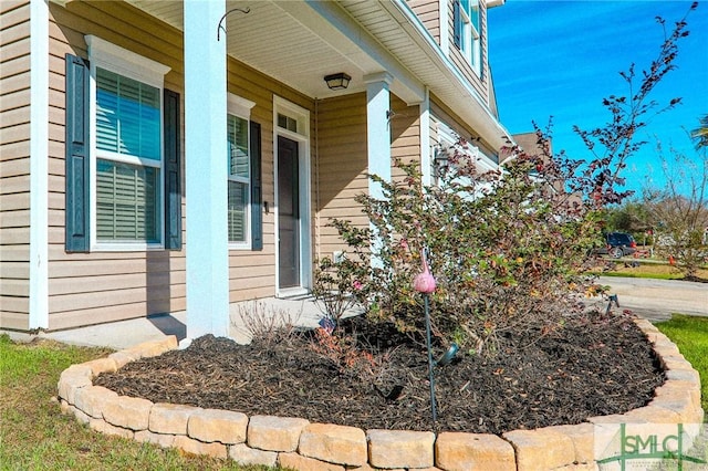 view of side of home with covered porch