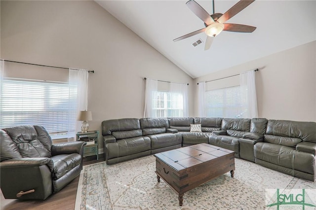 living room featuring ceiling fan, high vaulted ceiling, and light hardwood / wood-style flooring