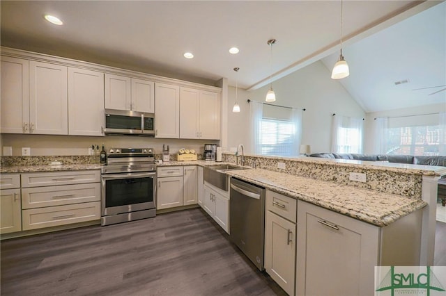 kitchen with white cabinets, sink, hanging light fixtures, and appliances with stainless steel finishes