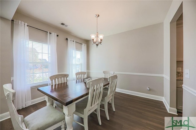 dining area featuring plenty of natural light, dark hardwood / wood-style floors, and a notable chandelier