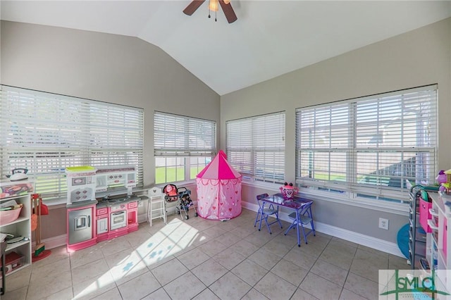 game room featuring ceiling fan, light tile patterned floors, and lofted ceiling