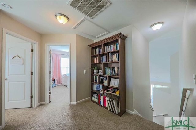 hall featuring light colored carpet