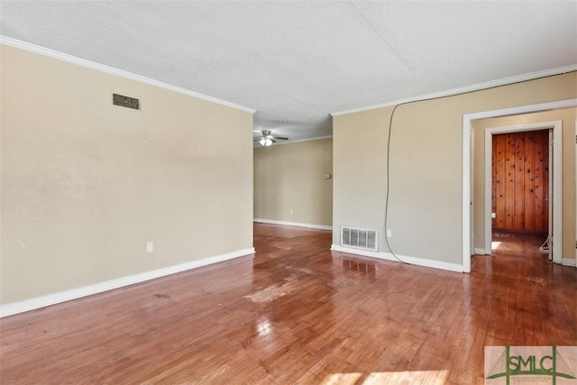 spare room with hardwood / wood-style flooring, ceiling fan, a textured ceiling, and ornamental molding