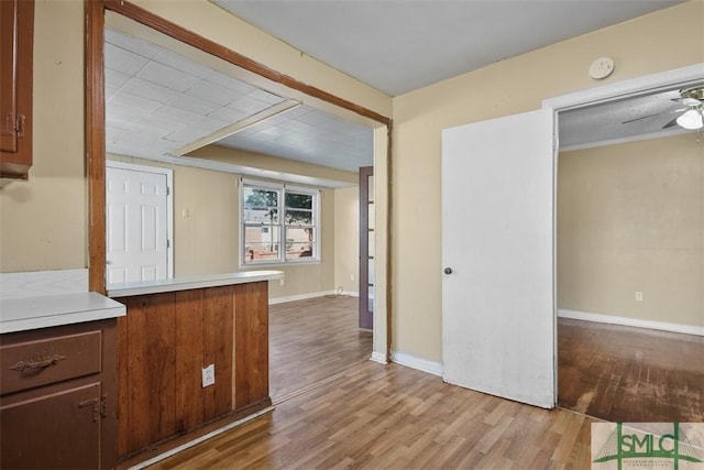 kitchen featuring ceiling fan and light hardwood / wood-style floors