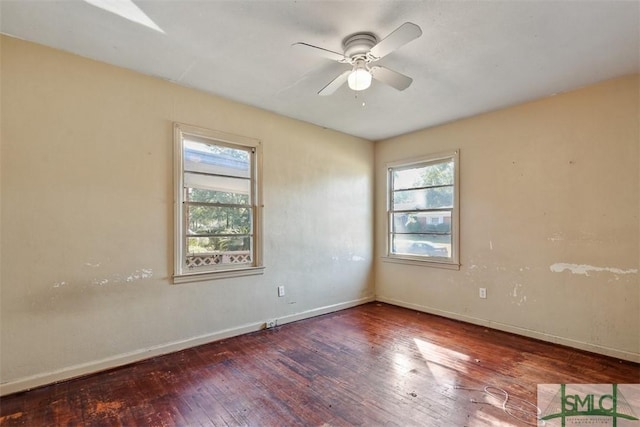 spare room with ceiling fan, a healthy amount of sunlight, and wood-type flooring