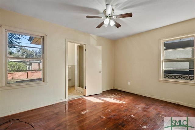 unfurnished bedroom featuring hardwood / wood-style floors, ensuite bathroom, and ceiling fan