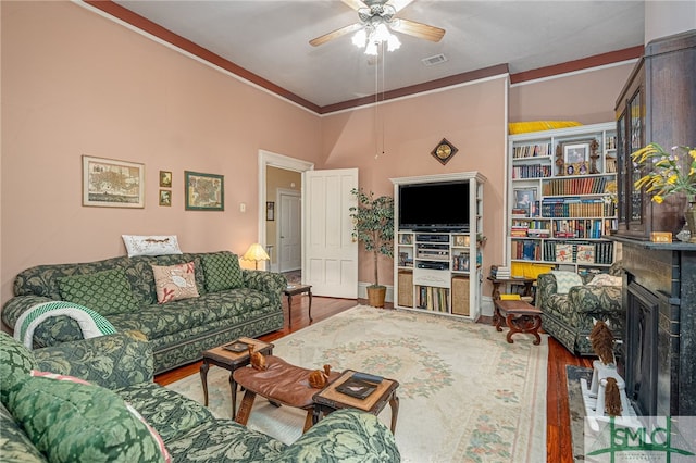 living room featuring ceiling fan and wood-type flooring