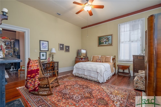 bedroom featuring ceiling fan and dark hardwood / wood-style flooring