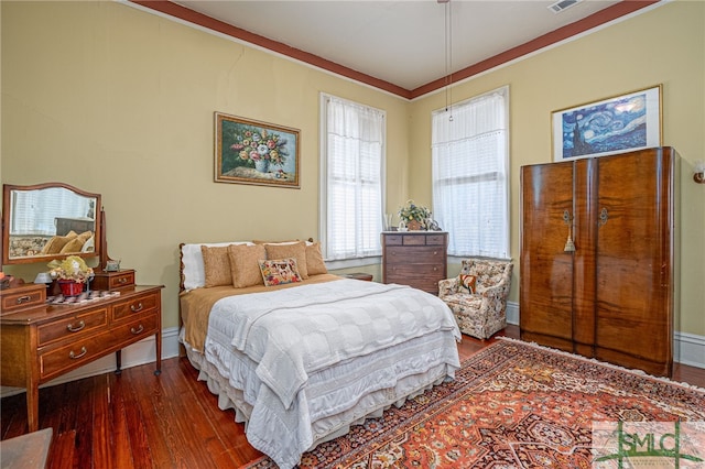 bedroom with dark hardwood / wood-style flooring