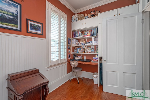 home office featuring crown molding and light hardwood / wood-style floors