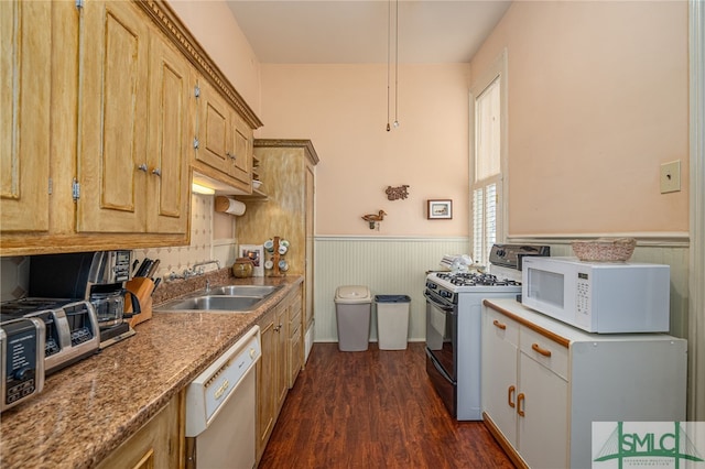 kitchen with light brown cabinets, white appliances, dark hardwood / wood-style floors, and sink