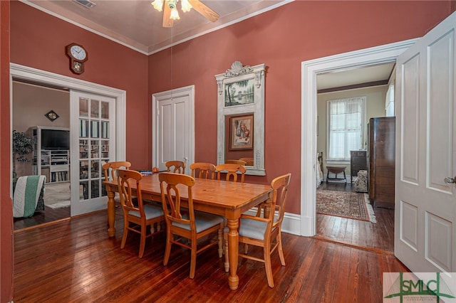 dining room with ceiling fan, dark hardwood / wood-style flooring, ornamental molding, and french doors