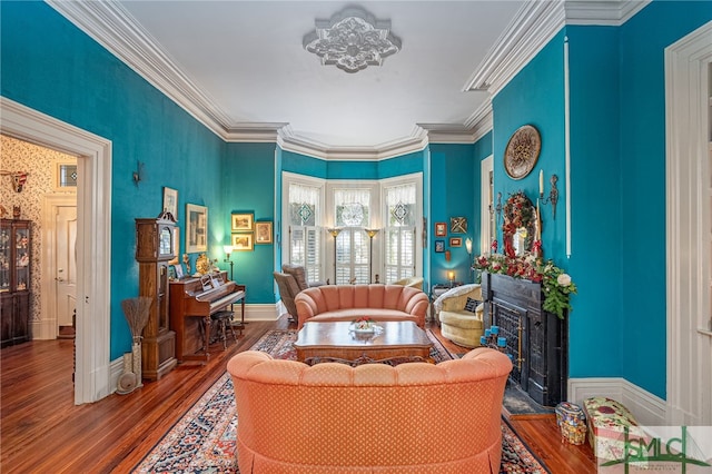 living area with a high end fireplace, hardwood / wood-style flooring, and crown molding