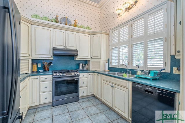 kitchen featuring light tile patterned flooring, appliances with stainless steel finishes, cream cabinets, and sink