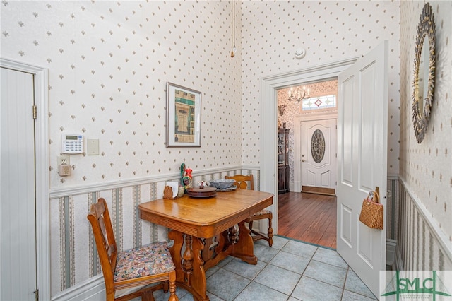 dining space featuring light tile patterned floors and an inviting chandelier