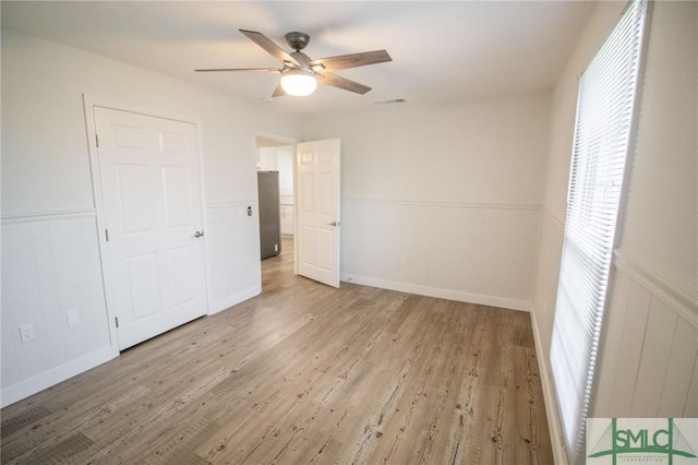 unfurnished bedroom with ceiling fan and light hardwood / wood-style floors