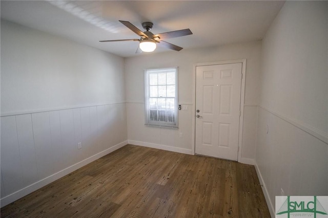 empty room with ceiling fan and dark wood-type flooring