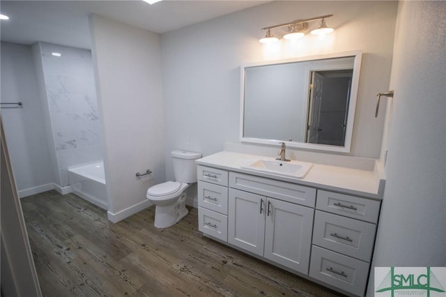 full bathroom featuring bathtub / shower combination, vanity, hardwood / wood-style flooring, and toilet