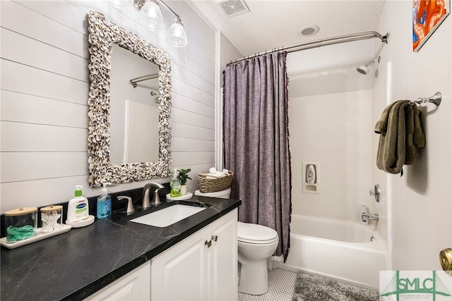 full bathroom featuring wooden walls, shower / bath combination with curtain, a textured ceiling, and vanity