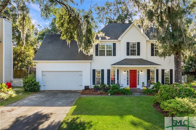 view of front of home with a garage and a front lawn