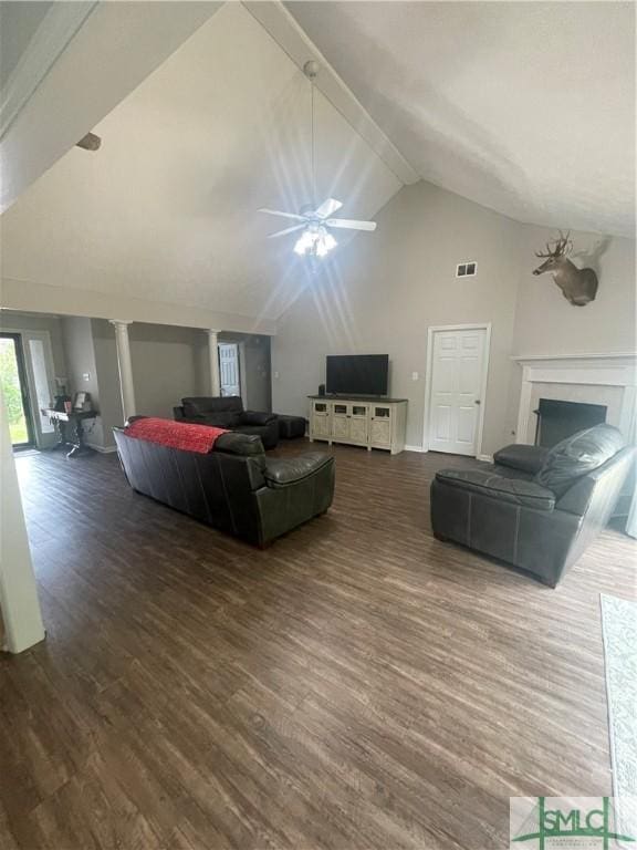 living room featuring ceiling fan, dark hardwood / wood-style flooring, beamed ceiling, and high vaulted ceiling