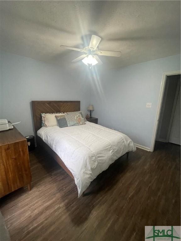 bedroom with ceiling fan and dark wood-type flooring