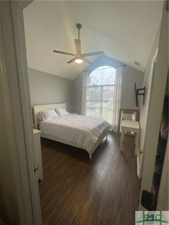 bedroom with dark hardwood / wood-style floors, ceiling fan, and lofted ceiling