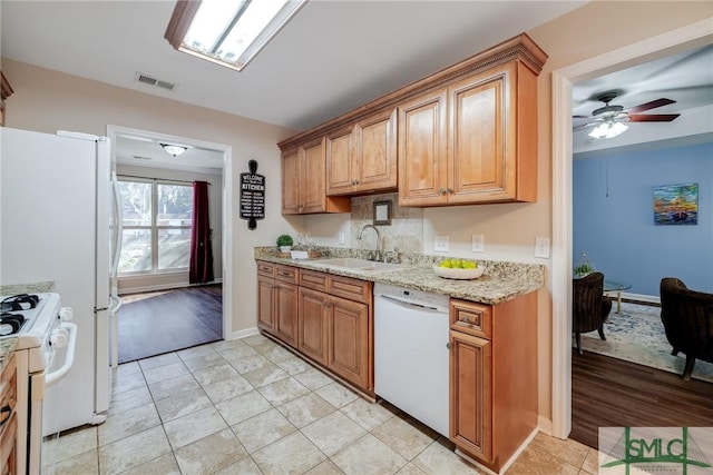 kitchen with backsplash, white appliances, ceiling fan, sink, and light tile patterned floors