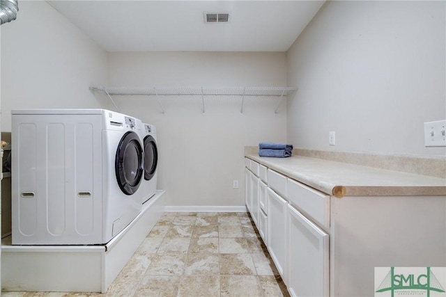 laundry area featuring cabinets and independent washer and dryer