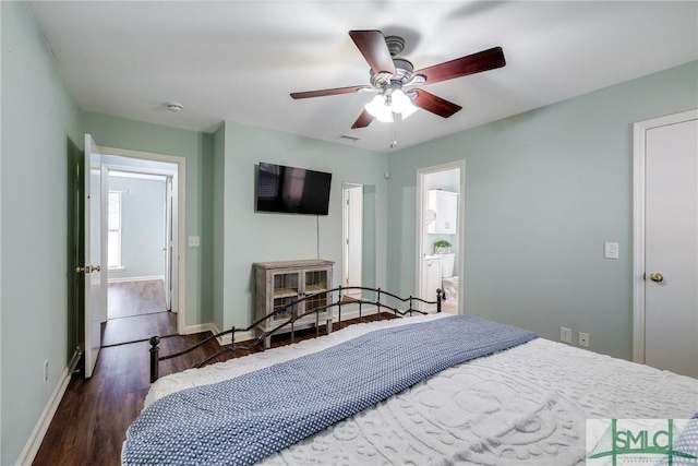 bedroom featuring ceiling fan, dark wood-type flooring, and ensuite bath