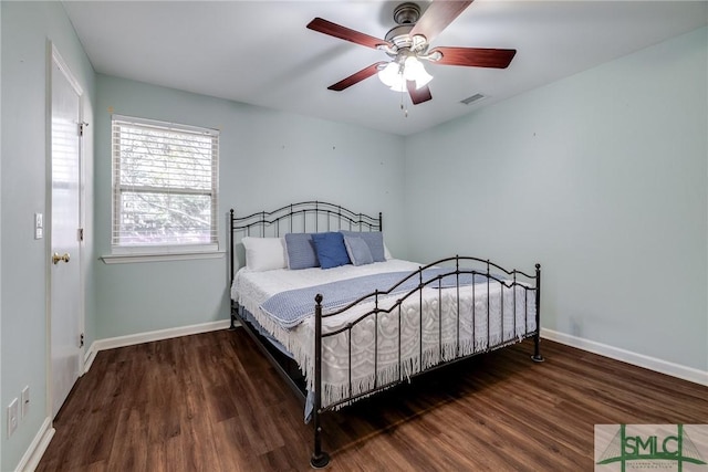 bedroom with ceiling fan and dark hardwood / wood-style flooring