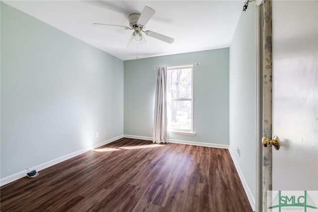 empty room with dark hardwood / wood-style floors and ceiling fan