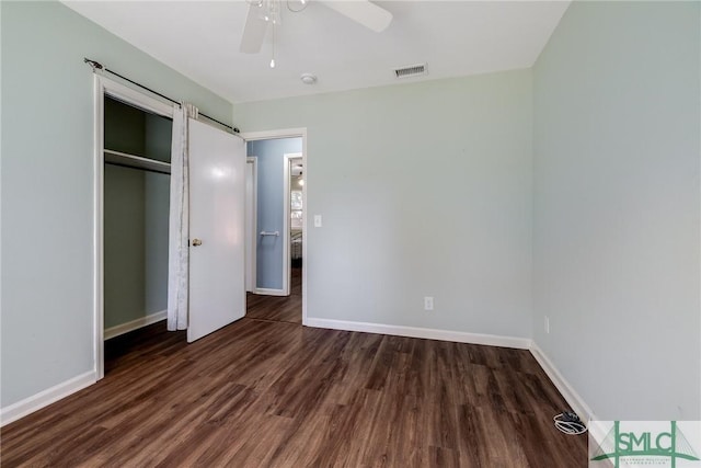 unfurnished bedroom featuring ceiling fan, a closet, and dark hardwood / wood-style floors