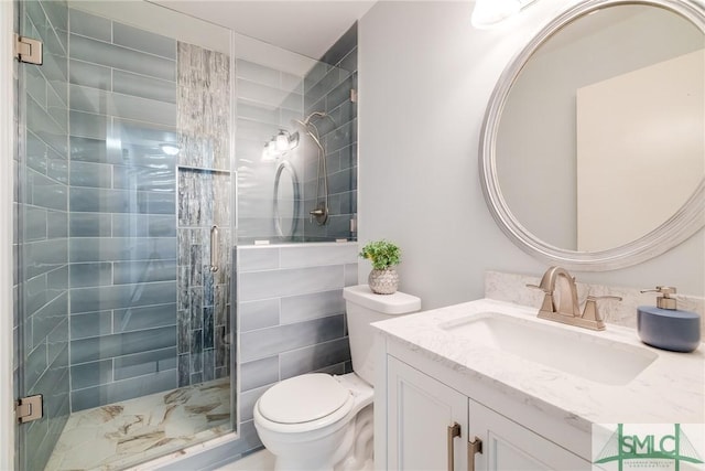 bathroom featuring vanity, toilet, and an enclosed shower