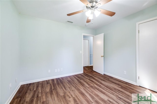 empty room featuring hardwood / wood-style flooring and ceiling fan