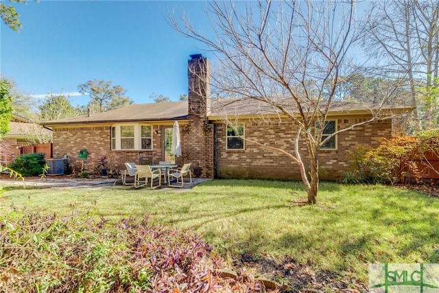 9 Mulberry Ct, Savannah, GA 31406 - back of property featuring brick siding, central AC, a patio, and a yard