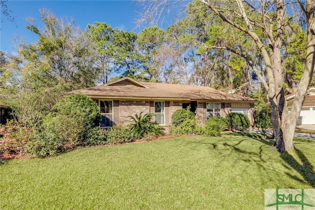 single story home with a front yard and a garage