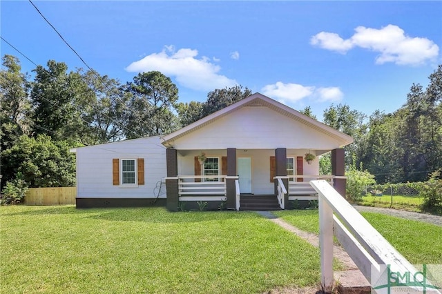 view of front of home with a front yard and a porch