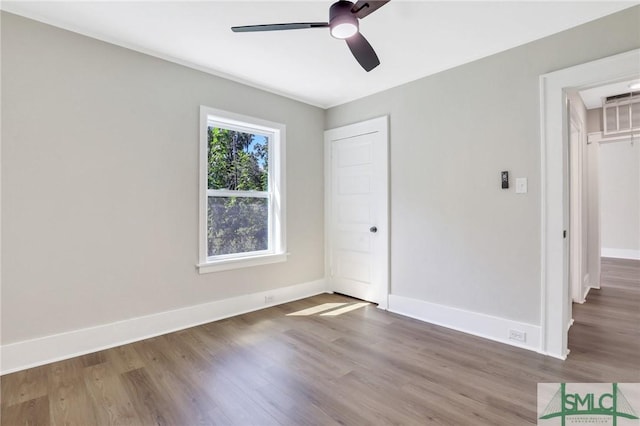 unfurnished bedroom featuring ceiling fan, a closet, and hardwood / wood-style floors