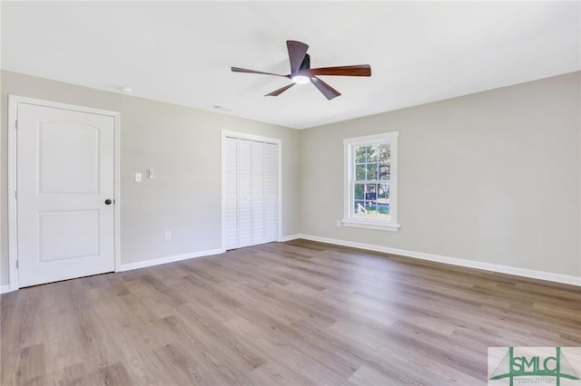 unfurnished bedroom with ceiling fan and light wood-type flooring