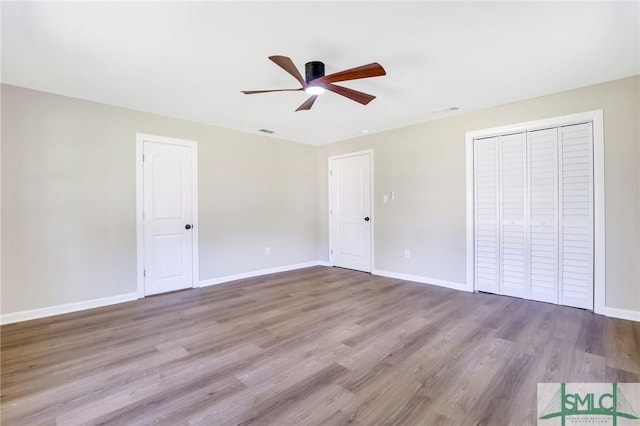 unfurnished bedroom with light hardwood / wood-style flooring and ceiling fan